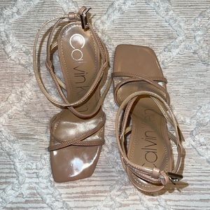 Ankle strap nude heels.